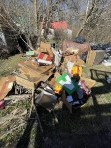 A large pile of cardboard boxes and miscellaneous trash outdoors, ready for efficient junk removal by Trash Monkey Junk Removal in Charleston, WV.
