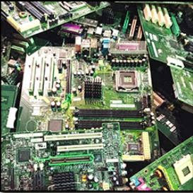 A pile of computer motherboards and circuit boards for e-waste recycling by RAR Reliable Asset Recovery, Inc. in Nashua, NH
