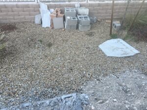 A pile of concrete blocks and tiles in a gravel yard, awaiting removal by MGM Household Services in Las Vegas, NV.