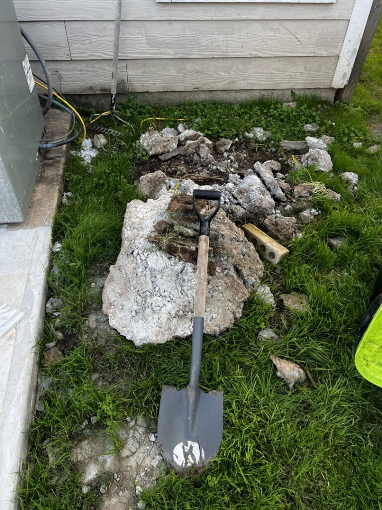 A pile of concrete chunks and debris next to a house, ready for Handymen Junk Removal in Houston, TX.