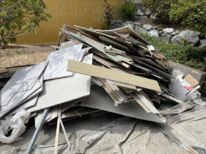 A large pile of construction debris, including drywall and wood, ready for removal by Junk Commandos in Tacoma, WA.