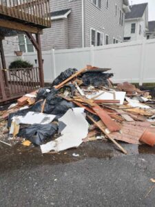 A large pile of construction debris and general junk ready for removal by Champion Waste Removal, Inc. at a site in Orange, NJ.