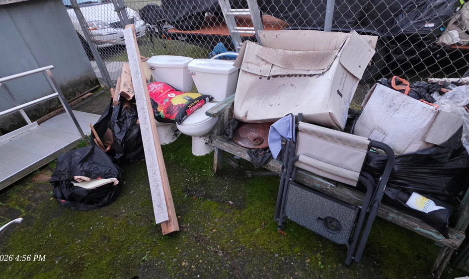A pile of household junk, including toilets and boxes, ready for removal by Squirrel Squad LLC in Portland, OR.
