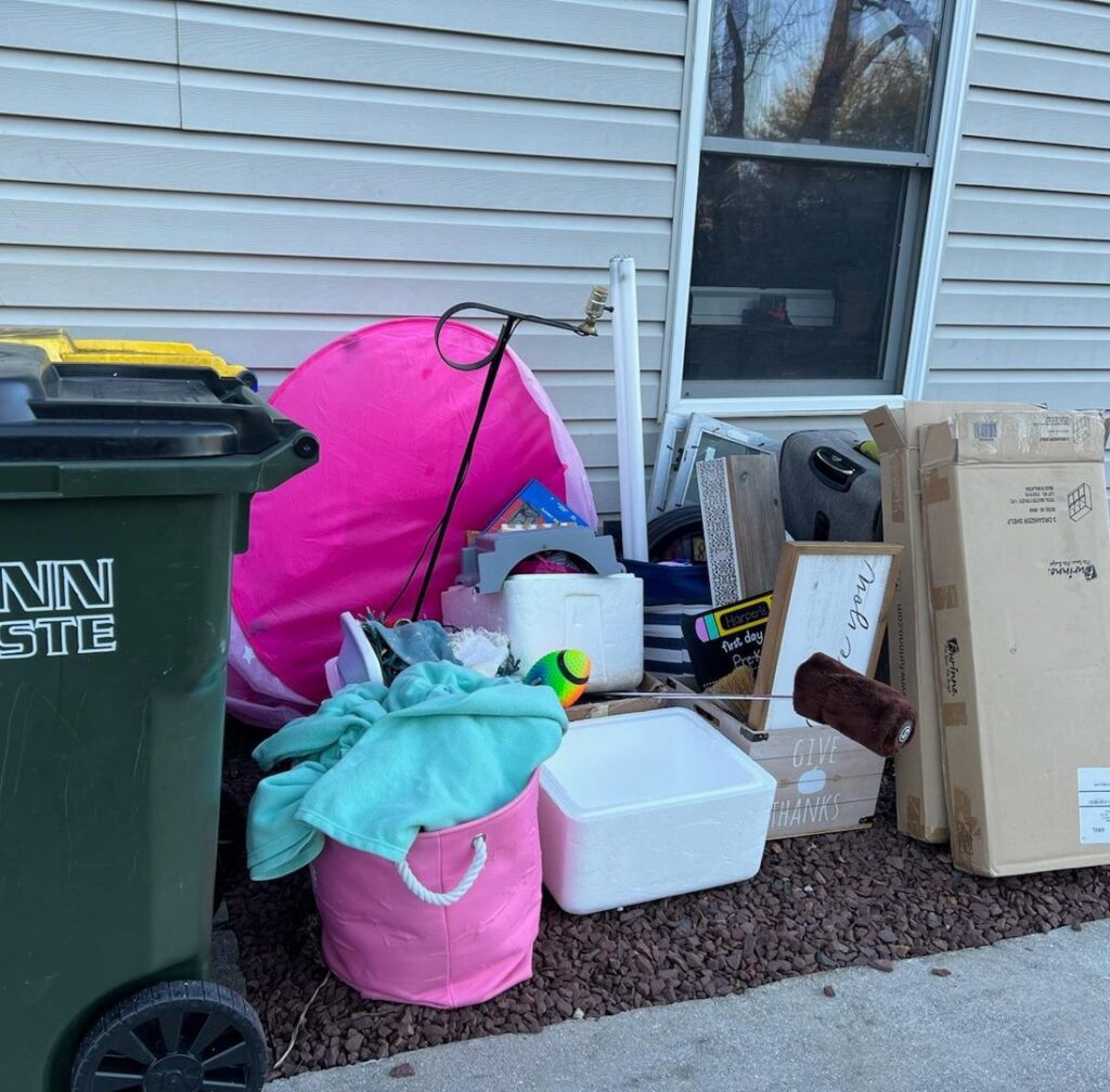 A pile of household junk and debris outside a house, ready for pickup by Junk Runner, LLC in East Berlin, PA.