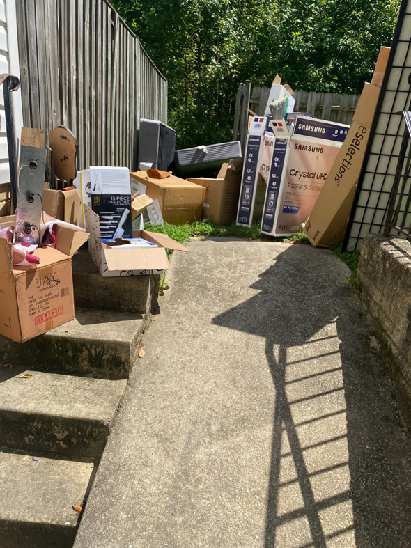 A large pile of cardboard boxes, old TVs, and other junk ready for removal by Total Junk and Bulk Disposal in Whitsett, NC