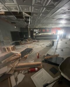 A large pile of household junk and debris next to a dump trailer, ready for removal by Mike's Dumper in Las Vegas, NV.