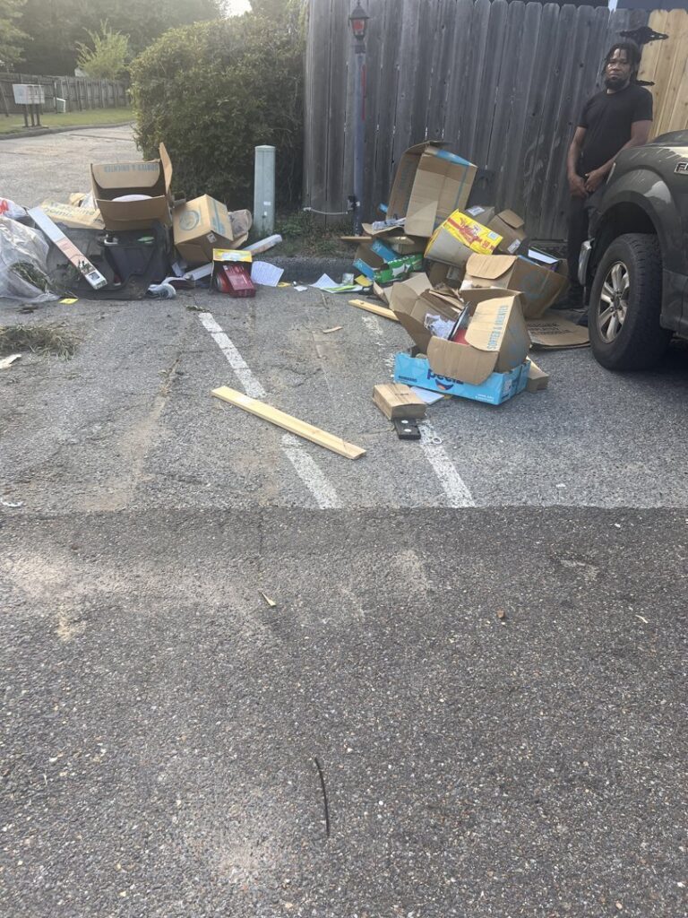 A large pile of cardboard boxes and various junk items awaiting removal by Bluff City Dumpsters in Memphis, TN.