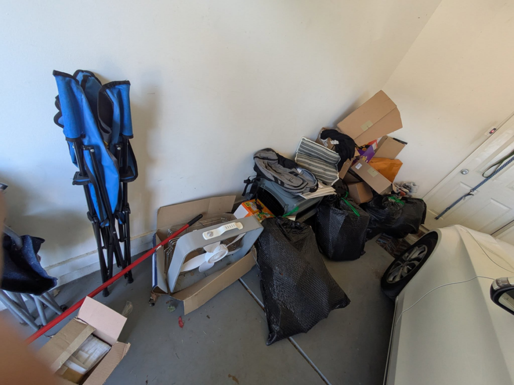 A pile of miscellaneous junk, including chairs, boxes, and bags, ready for removal by Haul Squad in Helena, AL.