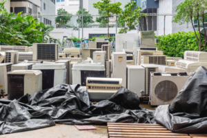 A large pile of old air conditioning units and scrap metal ready for recycling at RZR Mechanical LLC in Phoenix, AZ.