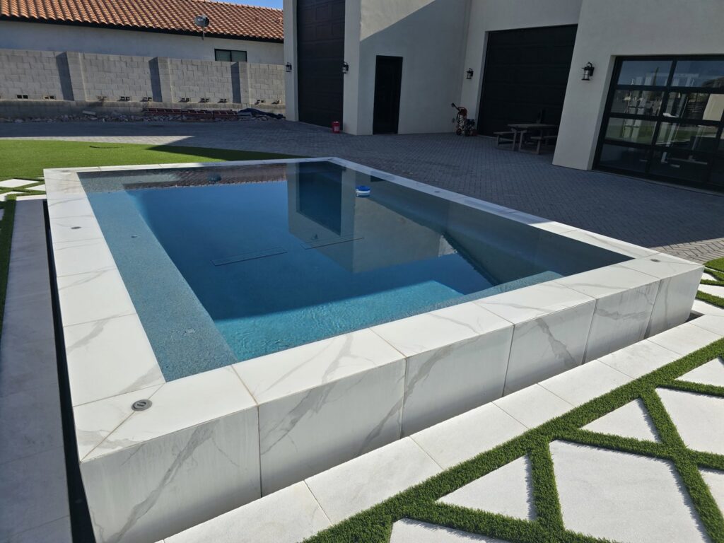 A pile of old pool equipment and pipes removed during a renovation by Aqua Squad Pools & Landscaping in Gilbert, AZ.