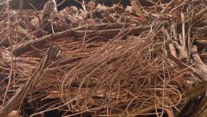 A close-up view of a large pile of tangled scrap copper wires at Queen City Metal Recycling & Salvage in Charlotte, NC.