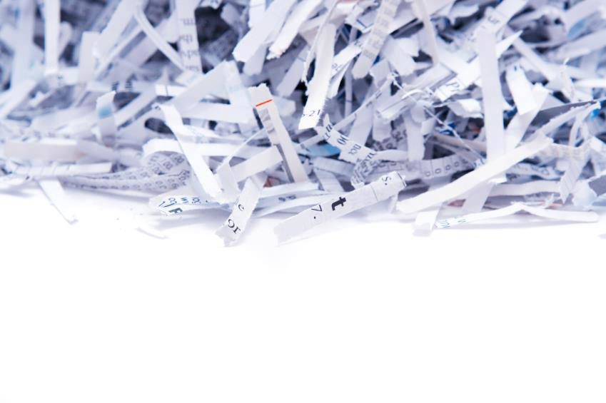 A large pile of securely shredded paper, representing document destruction by Docu Shred Inc. in Fisher, MN.