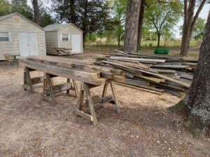 A large pile of old wood planks and debris ready for removal by NTX Haul Away Junk Removal in Fort Worth, TX.
