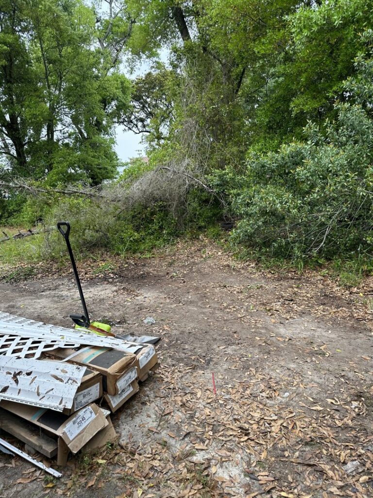 A pile of wood debris and yard waste in a residential area, awaiting removal by Clutter Control Junk Removal and Demo in Biloxi, MS.