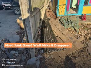 A pile of wooden debris and other junk next to a playhouse, awaiting removal by Siouxland Junk Removal in Sioux City, IA.