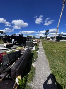 Piles of furniture and debris on a sidewalk awaiting removal by Anthony's Junk Removal & Delivery LLC in Cape Coral, FL.