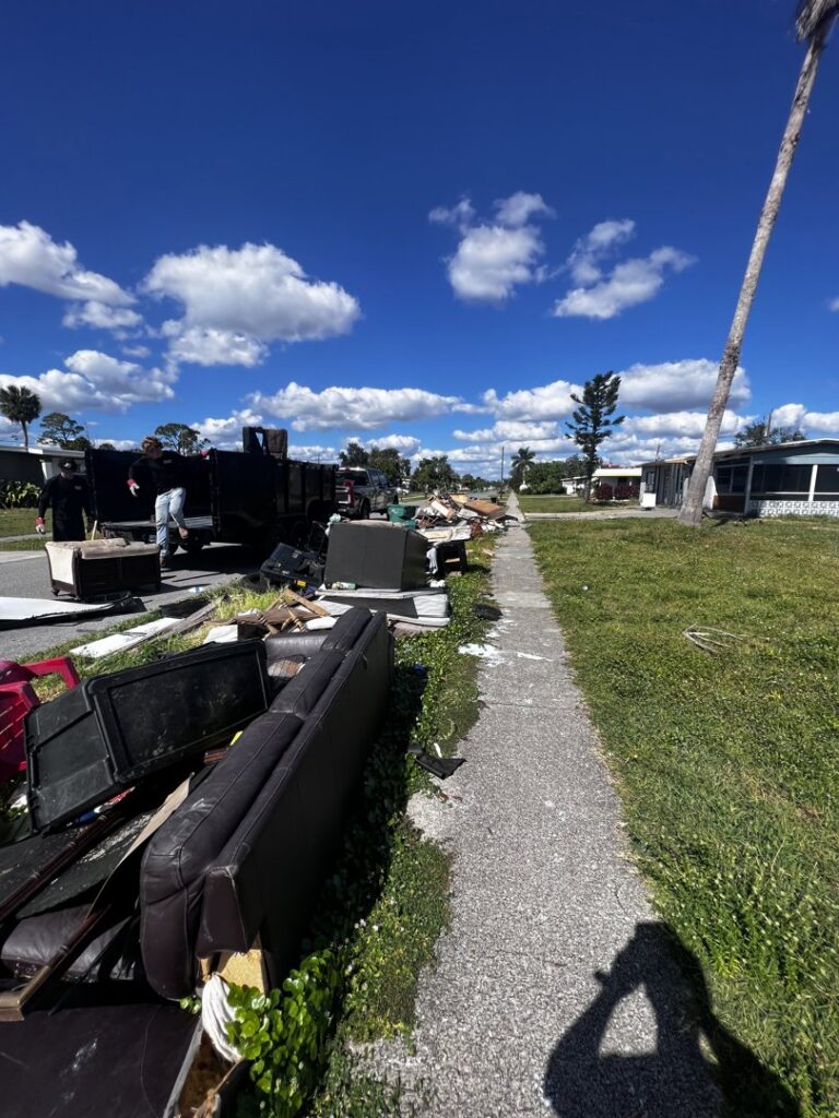 Piles of furniture and debris on a sidewalk awaiting removal by Anthony's Junk Removal & Delivery LLC in Cape Coral, FL.