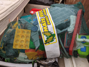 A mesh bag filled with plastic items and a mattress ready for disposal by Greater Upper Valley Solid Waste Management District in Ascutney, VT.