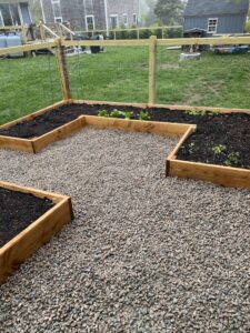 A newly assembled or installed wooden playset in a backyard by Woodbine Repair & Remodeling in Jamestown, RI.