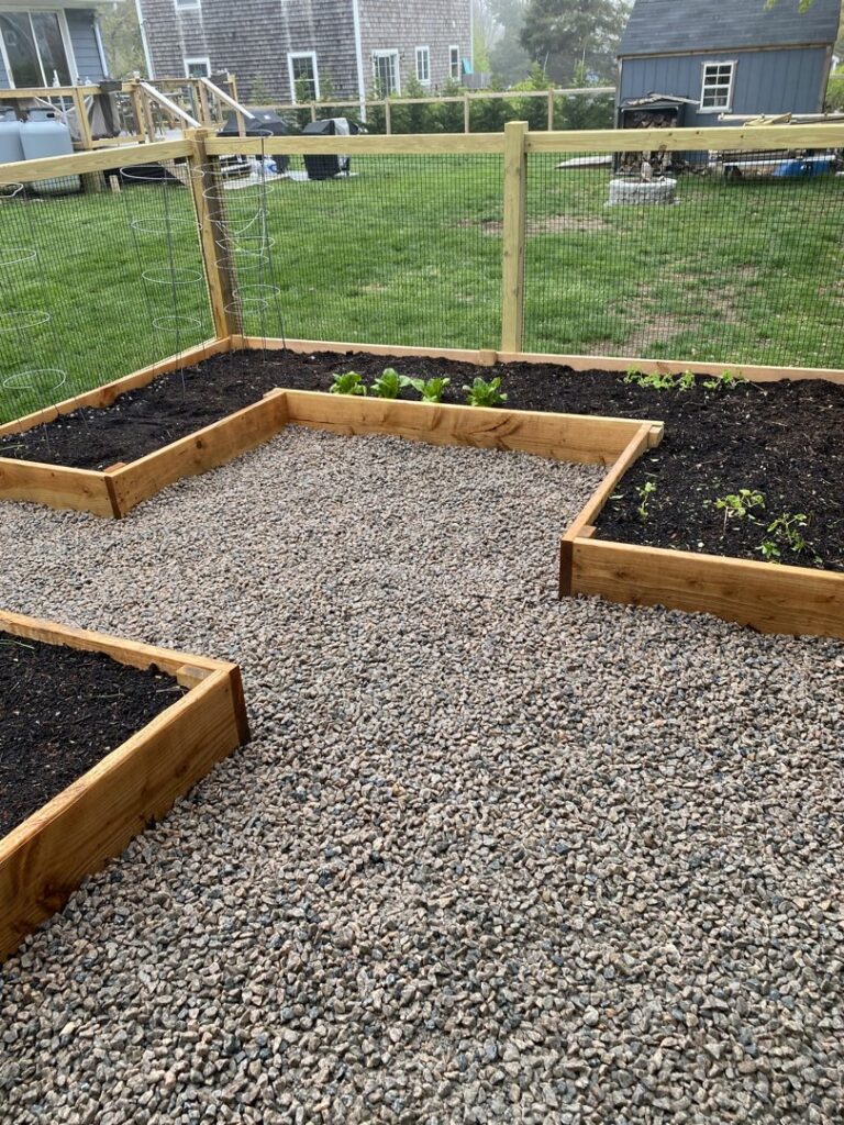 A newly assembled or installed wooden playset in a backyard by Woodbine Repair & Remodeling in Jamestown, RI.