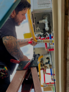 A plumber installing or repairing water lines and connections for Sandobros Plumbing in Charleston, SC