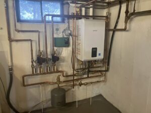 A plumber from Advanced Rooter Plumbing working in a trench on pipe repair in Norwalk, CT