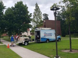 A plumber from Precision Plumbing & Drain Cleaning working on an outdoor drain system in Chesapeake, VA