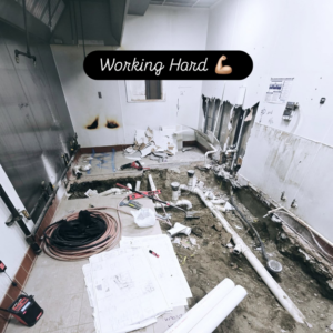 An active plumbing and renovation work site with exposed pipes and tools by Supreme Home Improvements in Channahon, IL