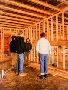 A team discussing plumbing installation within a barndominium project by Nashville Barndo Builders in Franklin, TN.