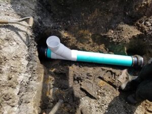 A close-up view of plumbing pipes being connected in a trench by Hessville Plumbing in Hammond, IN.