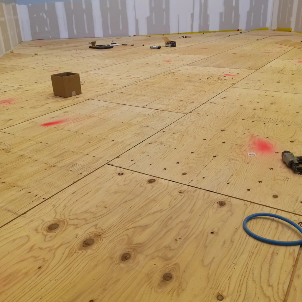 Plywood subfloor being installed with tools during a wood flooring project by Robert C. Mihaich Wood Flooring in Worcester, MA.