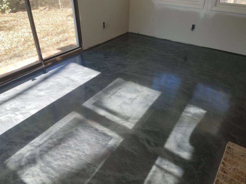 A sleek, polished interior concrete floor reflecting sunlight, installed by Rodriguez Concrete Creations in Rock Hill, SC.