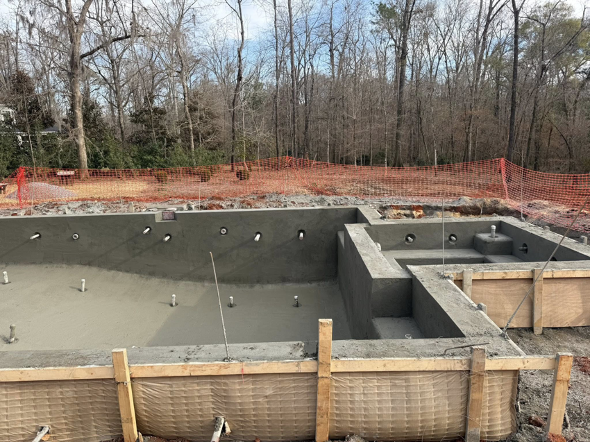 Concrete pool construction showing the shell walls and surrounding formwork by Ga Impact Shotcrete in Atlanta, GA.