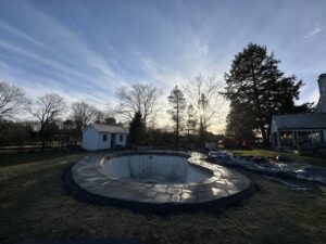 Workers installing new coping around the edge of a pool during renovation by CDO Pool & Hot Tub Renovation in Norwalk, CT.