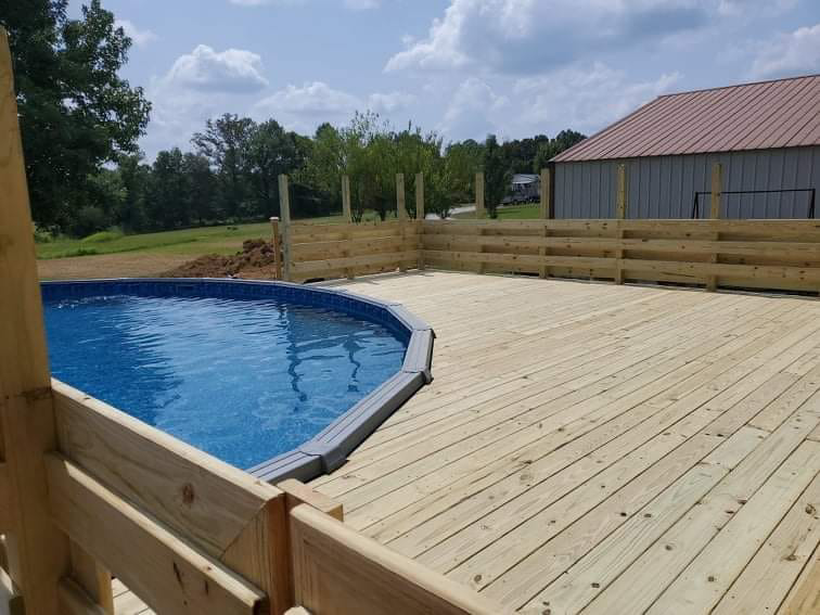 A newly constructed wooden pool deck and fence built by The House Doctor in Hopkinsville, KY.
