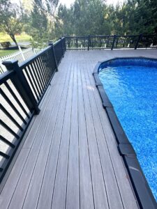 A newly installed composite deck surrounding an above-ground pool by Stanley Contracting in Whiting, NJ
