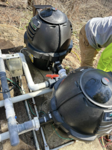 Two pool pump and filter systems with plumbing, indicating installation or maintenance by B-rod Pool Service LLC in Norwalk, CT.
