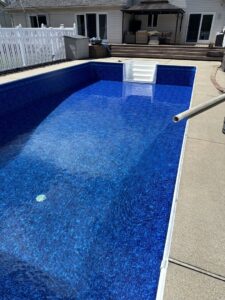 A swimming pool being filled with water after a liner replacement by Heatwave Pools LLC in Flint, MI.
