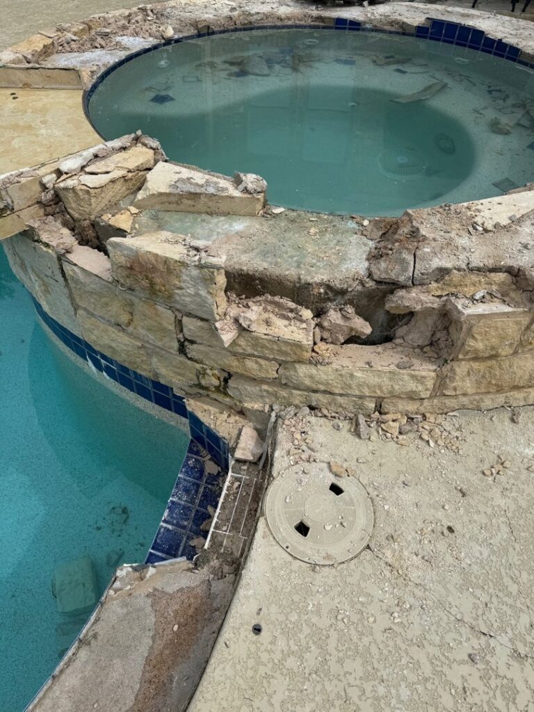 A swimming pool and hot tub area undergoing renovation and demolition by 5 Daughters Total Outdoors in Austin, TX.
