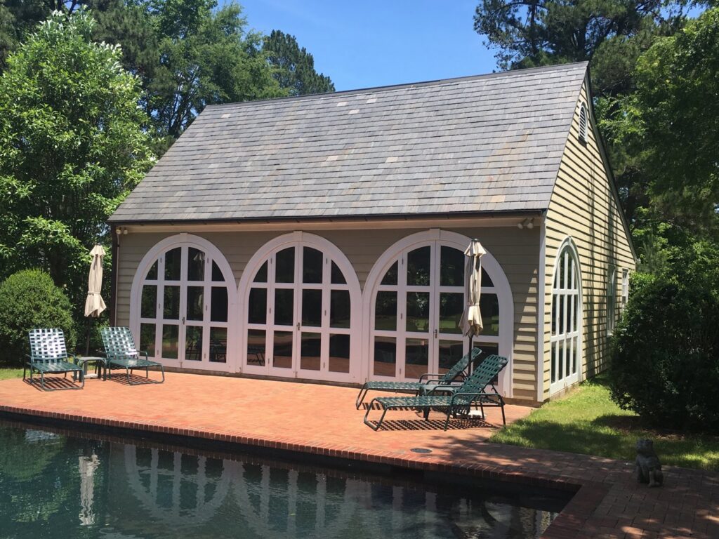 A pool house with large arched windows, ideal for UV control and window tinting services by Augusta Sun & UV Control in Augusta, GA.