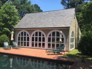 A pool house with large arched windows, ideal for UV control and window tinting services by Augusta Sun & UV Control in Augusta, GA.