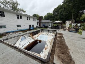Workers resurfacing the interior of a pool as part of a renovation by CDO Pool & Hot Tub Renovation in Norwalk, CT.