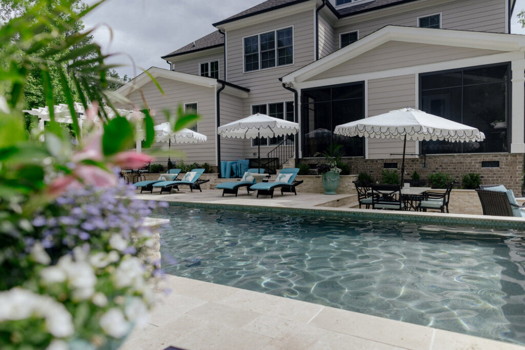 A serene pool and patio area with elegant outdoor furniture, designed by Extreme Pools Renovation in Raleigh, NC.