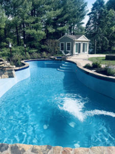A newly resurfaced pool being refilled with water, showcasing pool maintenance by Sublime Pools RVA in Richmond, VA.