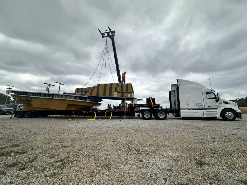 A crane lifting a composite pool shell into place during installation by Composite Pools USA in Newfield, NJ.