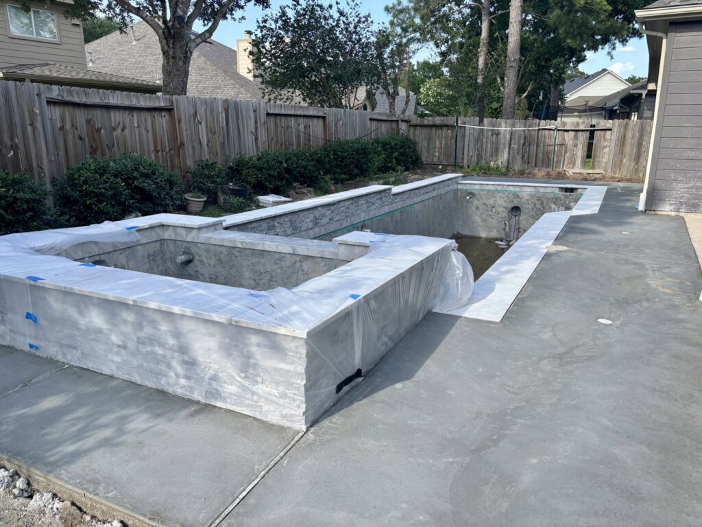 A custom pool and spa construction project in progress, showing concrete work and framing by Limitless Custom Pools and Backyards in Houston, TX.