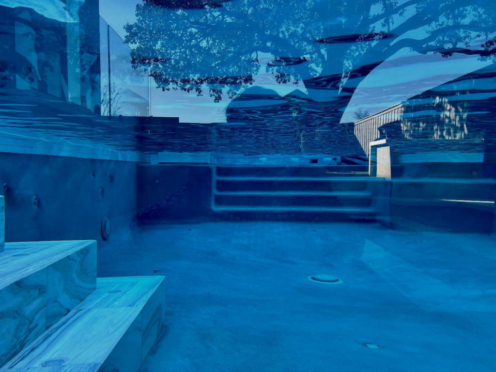 An underwater view of a pool structure with steps, built by First Class Pools & Spas in Sachse, TX.