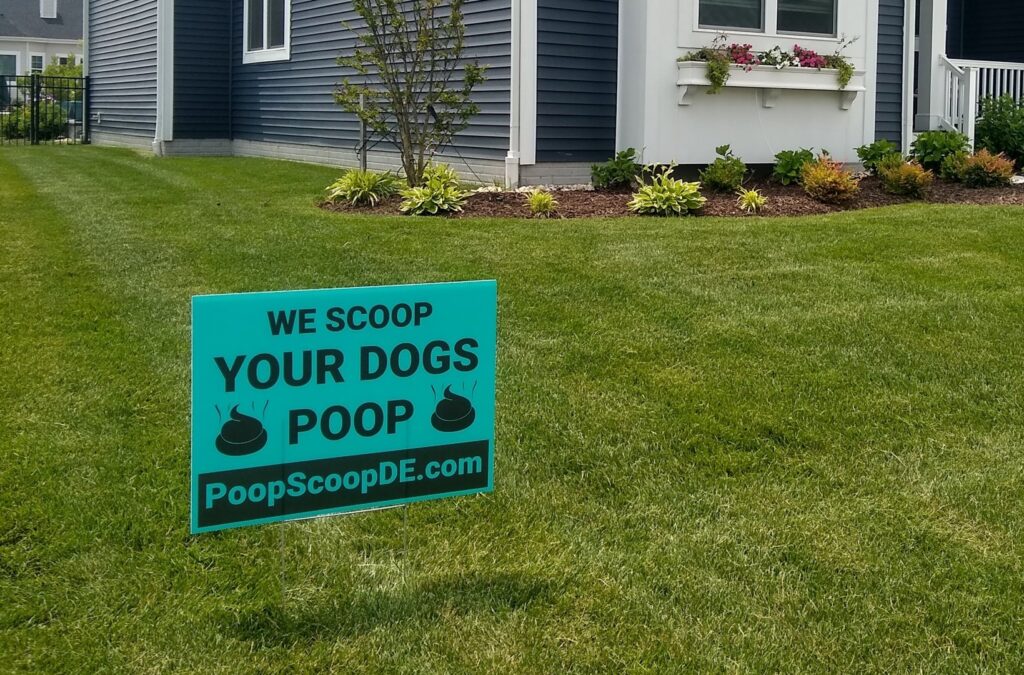 A 'We Scoop Your Dogs Poop' sign displayed on a green lawn, indicating pet waste removal services by They Poop We Scoop in Lewes, DE.