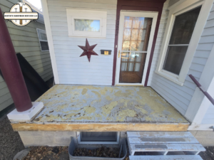 An old porch with peeling material before resurfacing by Dustin's Handyman Services LLC in Great Falls, MT.