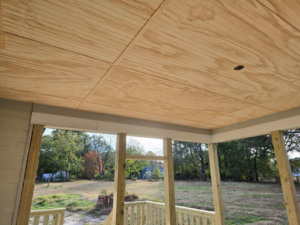 View of a newly installed plywood porch ceiling and wooden support structure by MAF Construction LLC in Raleigh, NC